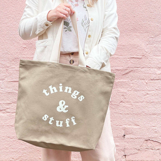 Stone canvas tote bag with "Things & Stuff" print, mid-length handles, ideal for everyday use.