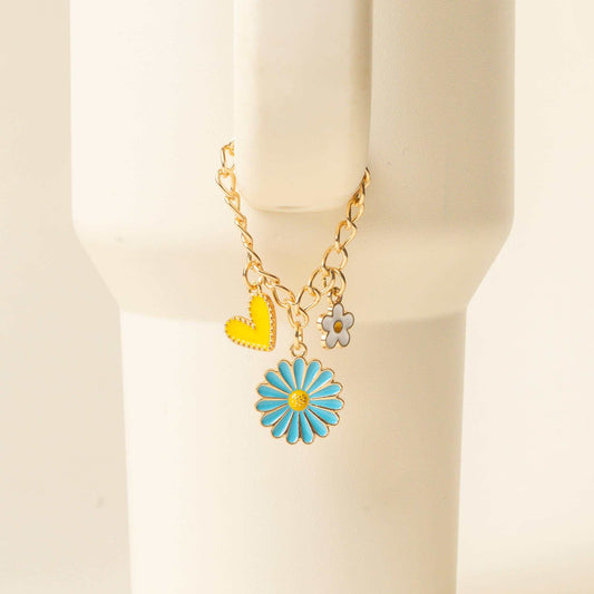 Tumbler Charm-Radiant Delight set with blue flower, yellow heart, and daisy charms on tumbler handle.