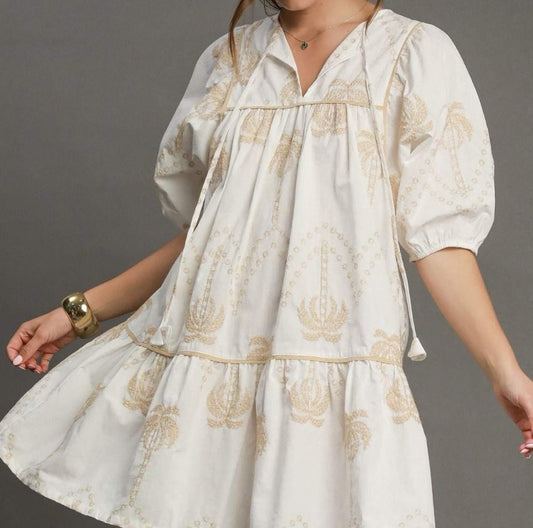 Umgee Boho Dress with cream and tan patterns, puff sleeves, and tassel details.