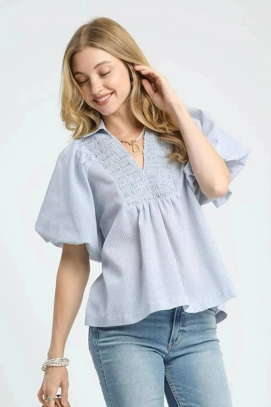 Umgee Smocked Puff Sleeve Blouse in light blue pinstripe with smocked detailing and bell sleeves.
