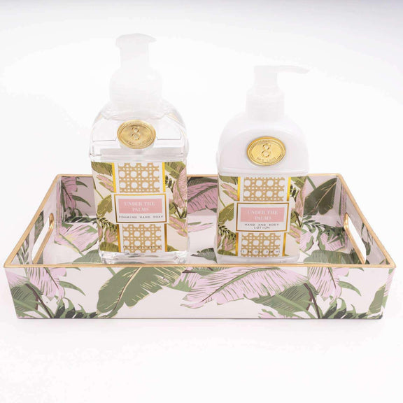 Under the Palms 300ml Hand & Body Lotion with botanical print packaging on decorative tray.